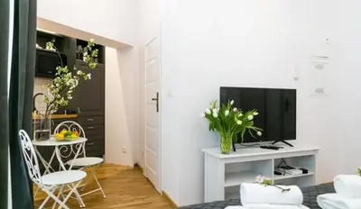 a living room with a kitchen and a dining room at Old Town Apt - Wielopole studio W6 in Kraków