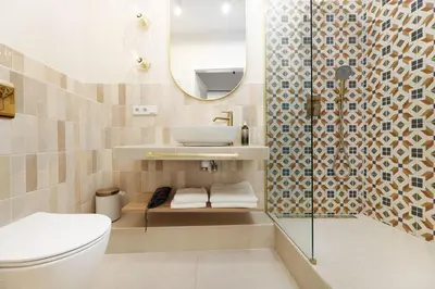 a bathroom with a toilet and a sink and a mirror at Hetman Main Square Apartments in Kraków