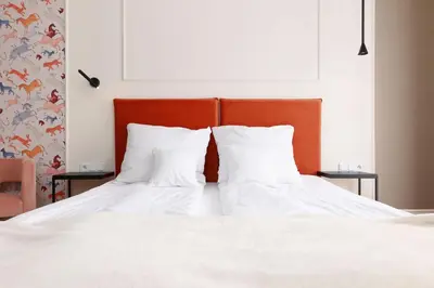 two white pillows sitting on a bed in a bedroom at Hetman Main Square Apartments in Kraków