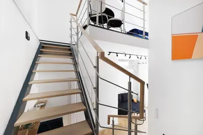 a spiral staircase in a room with a stair case at Hetman Main Square Apartments in Kraków