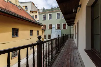 a walkway between two buildings in a city at Hetman Main Square Apartments in Kraków