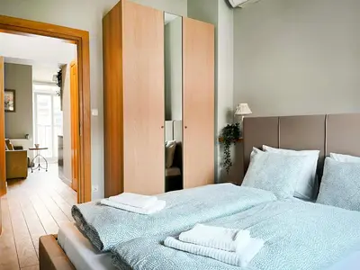 a bedroom with a bed with two towels on it at Welcoming Apartments with bedrooms and Air Conditioning, city center in Kraków