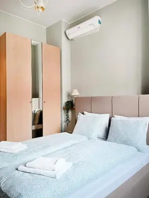a bedroom with a bed with two towels on it at Welcoming Apartments with bedrooms and Air Conditioning, city center in Kraków