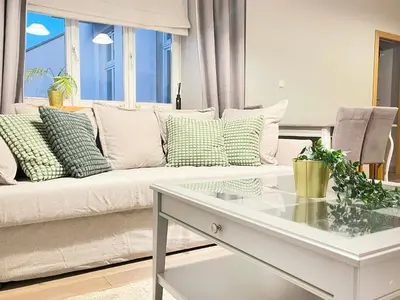 a living room with a couch and a table at Welcoming Apartments with bedrooms and Air Conditioning, city center in Kraków
