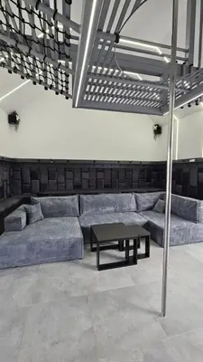 a living room with two beds and a table at Secret Barn in Michalczowa