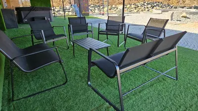 a group of chairs and a table on the grass at Secret Barn in Michalczowa