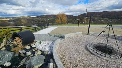 a playground with a fire pit and a swing at Secret Barn in Michalczowa