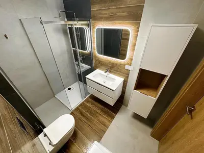 a small bathroom with a toilet and a sink at Apartamenty N, Trąbki in Wieliczka