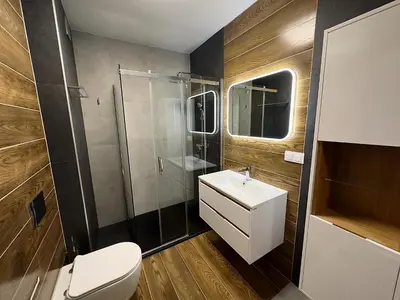 a bathroom with a toilet and a sink and a shower at Apartamenty N, Trąbki in Wieliczka