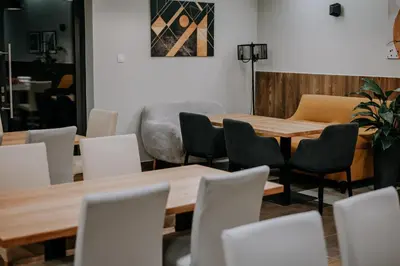 a dining room with wooden tables and chairs at Apartamenty N, Trąbki in Wieliczka