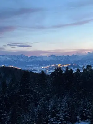 a view of a city from a mountain at dusk at Apartament Zielone Wzgórze Pod Turbaczem in Nowy Targ