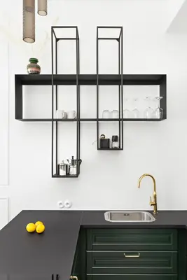 a kitchen with a black counter and a sink at Starowiślna Apartments by Tyzenhauz in Kraków