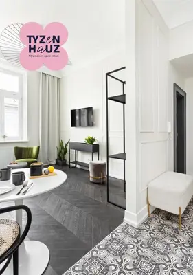 a living room with a table and a chair at Starowiślna Apartments by Tyzenhauz in Kraków