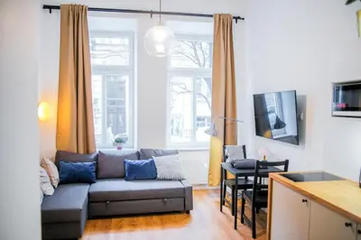 a living room with a couch and a table at Piano Apartments in Kraków