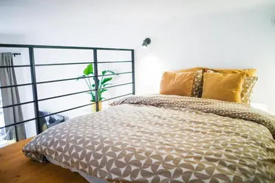 a bedroom with a bed with a metal headboard at Piano Apartments in Kraków