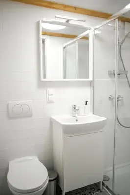 a bathroom with a toilet and a sink and a shower at Piano Apartments in Kraków