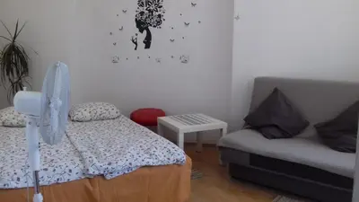 a small bedroom with a bed and a couch at Art Hostel in Kraków