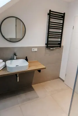 a bathroom with a sink and a mirror at Apart Home Raba Wyżna in Raba Wyżna