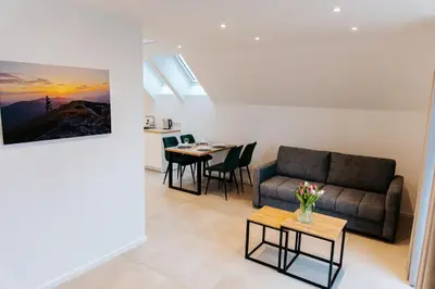 a living room with a couch and a table at Apart Home Raba Wyżna in Raba Wyżna