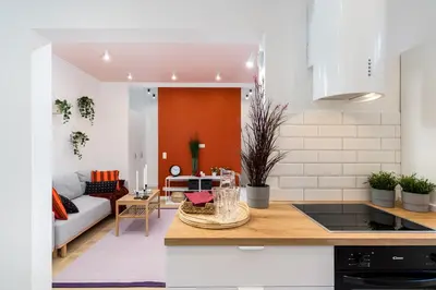 a kitchen and living room with a couch at Apartment near Main Station - Bosacka 8 street in Kraków