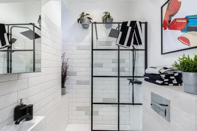 a bathroom with a shower with white subway tiles at Apartment near Main Station - Bosacka 8 street in Kraków