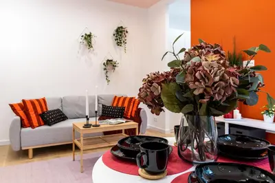 a living room with a vase of flowers on a table at Apartment near Main Station - Bosacka 8 street in Kraków