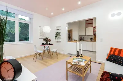 a living room with a clock and a table at Apartment near Main Station - Bosacka 8 street in Kraków