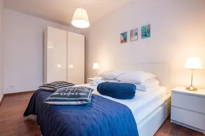 a bedroom with a bed with two pillows on it at Cozy apartment - Bosacka 10 street in Kraków