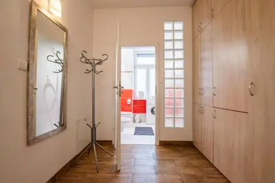 a hallway with a mirror and a door to a bathroom at Cozy apartment - Bosacka 10 street in Kraków