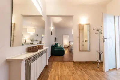 a living room with a green couch and a mirror at Cozy apartment - Bosacka 10 street in Kraków