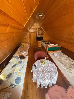 a room with two beds and a table in a tent at Rancho w Dolinie in Skomielna Biała