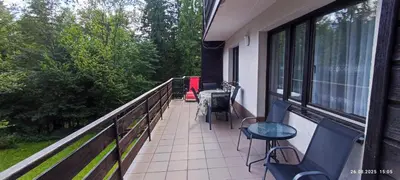 a balcony with chairs and a table on a balcony at Kwatery U Adama Zawoja in Zawoja
