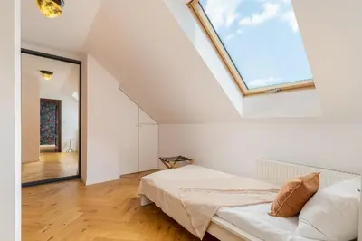 a bedroom with a bed and a large window at Luxury apartment in a truly PERFECT location in Kraków