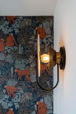 a light on a wall with a patterned wallpaper at Luxury apartment in a truly PERFECT location in Kraków