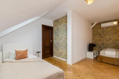 a bedroom with a bed and a wooden floor at Luxury apartment in a truly PERFECT location in Kraków