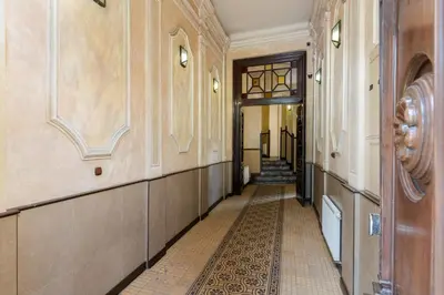 an empty hallway of a building with a tile floor at Luxury apartment in a truly PERFECT location in Kraków