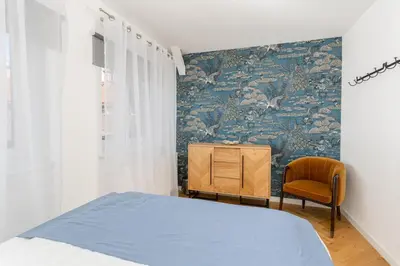 a bedroom with a bed and a dresser and a chair at Luxury apartment in a truly PERFECT location in Kraków