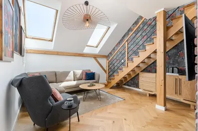 a living room with a couch and a staircase at Luxury apartment in a truly PERFECT location in Kraków