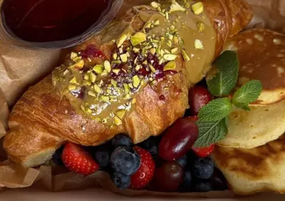 a bedroom with a large bed with red pillows at STRADONIA Serviced Apartments in Kraków
