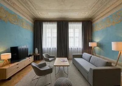 a living room with a couch and a tv at STRADONIA Serviced Apartments in Kraków