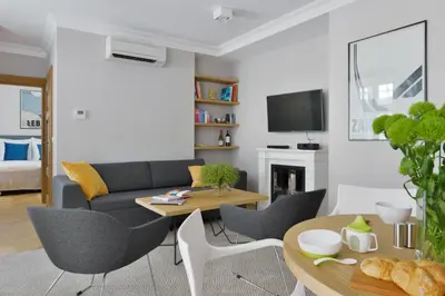 a living room with a couch and a table at STRADONIA Serviced Apartments in Kraków