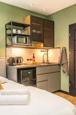 a kitchen with a sink and a microwave at Kraków Grzegórzki Studio - Central Station Nearby - by Rentujemy in Kraków