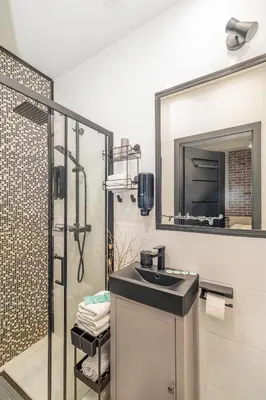 a bathroom with a sink and a mirror at Kraków Grzegórzki Studio - Central Station Nearby - by Rentujemy in Kraków
