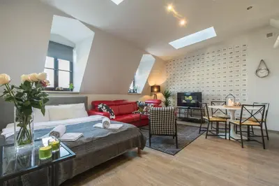 a living room with a couch and a table at 7 Koron - Exclusive Apartments in Kraków