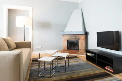a living room with a couch and a fireplace at Apartments Rynek Glowny in Kraków
