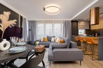 a living room with a couch and a table at Exclusive Apartment with Parking by Renters Prestige in Kraków