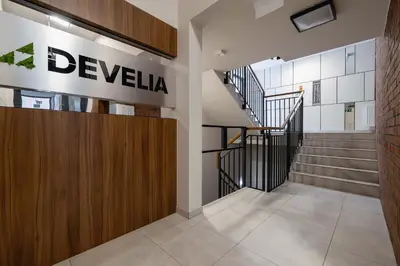 a staircase in a building with a sign on the wall at Exclusive Apartment with Parking by Renters Prestige in Kraków