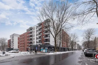 a snowy street with a building on the side of it at Exclusive Apartment with Parking by Renters Prestige in Kraków
