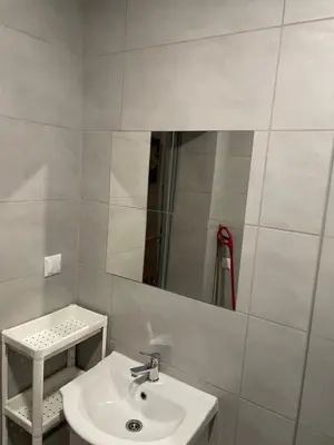 a bathroom with a sink and a mirror at Noclegi Eliza in Dąbrowa Górnicza