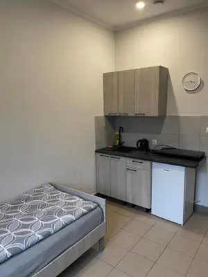 a kitchen with a bed and a counter top at Noclegi Eliza in Dąbrowa Górnicza